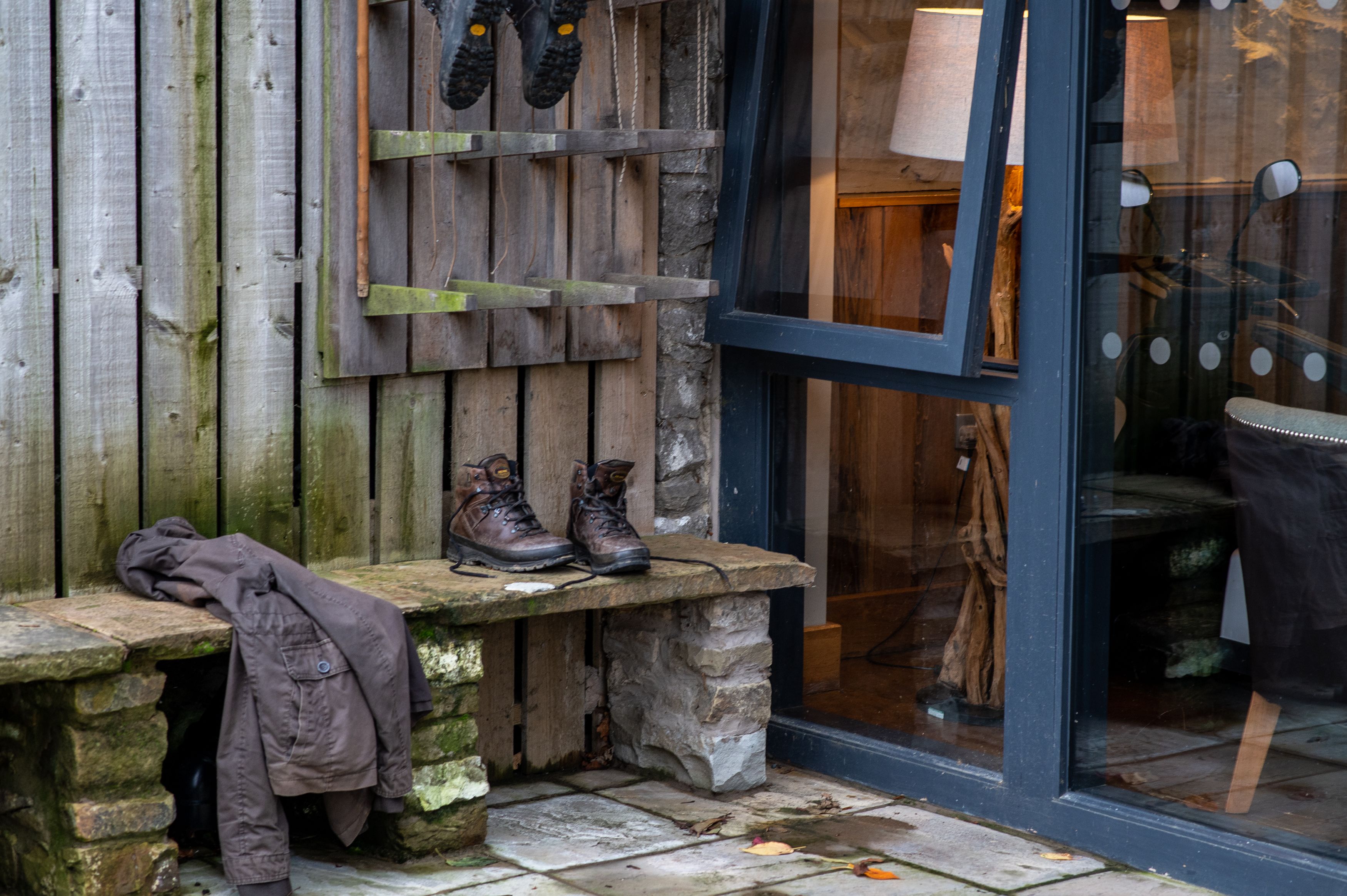 walking boots and jacket outside on bench