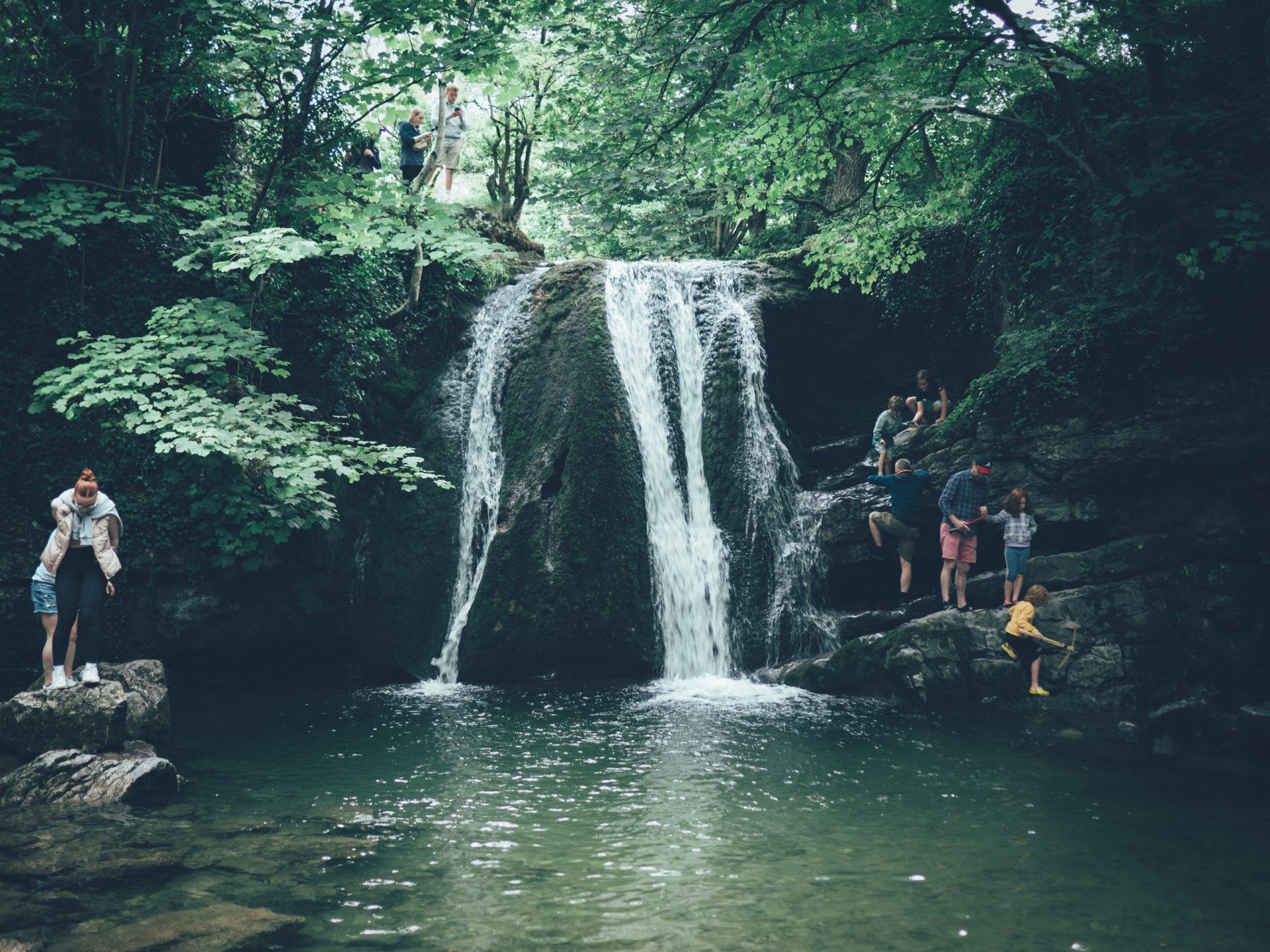 people climbing janet's foss waterfall