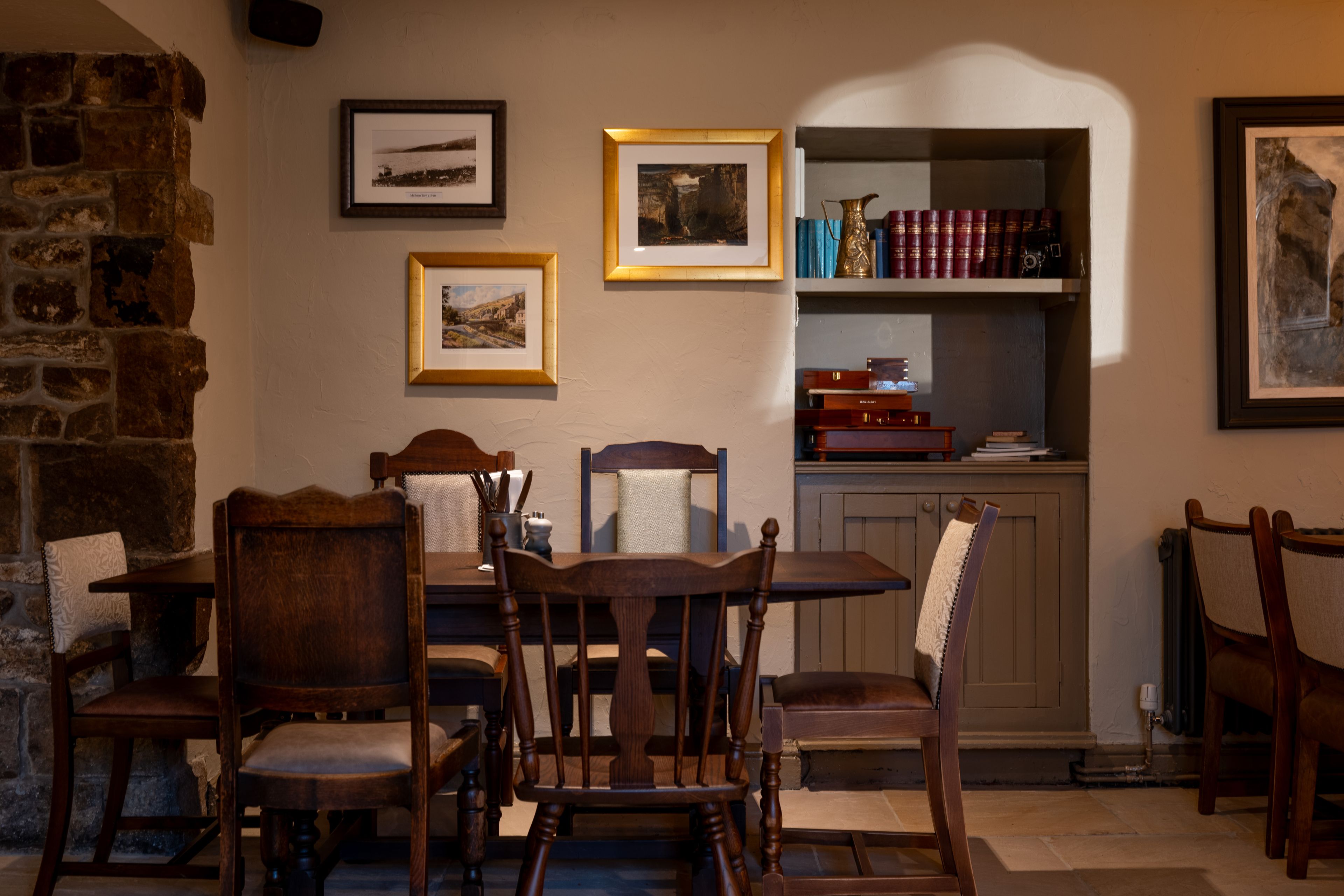 a table in the restaurant with local photography hung on the walls