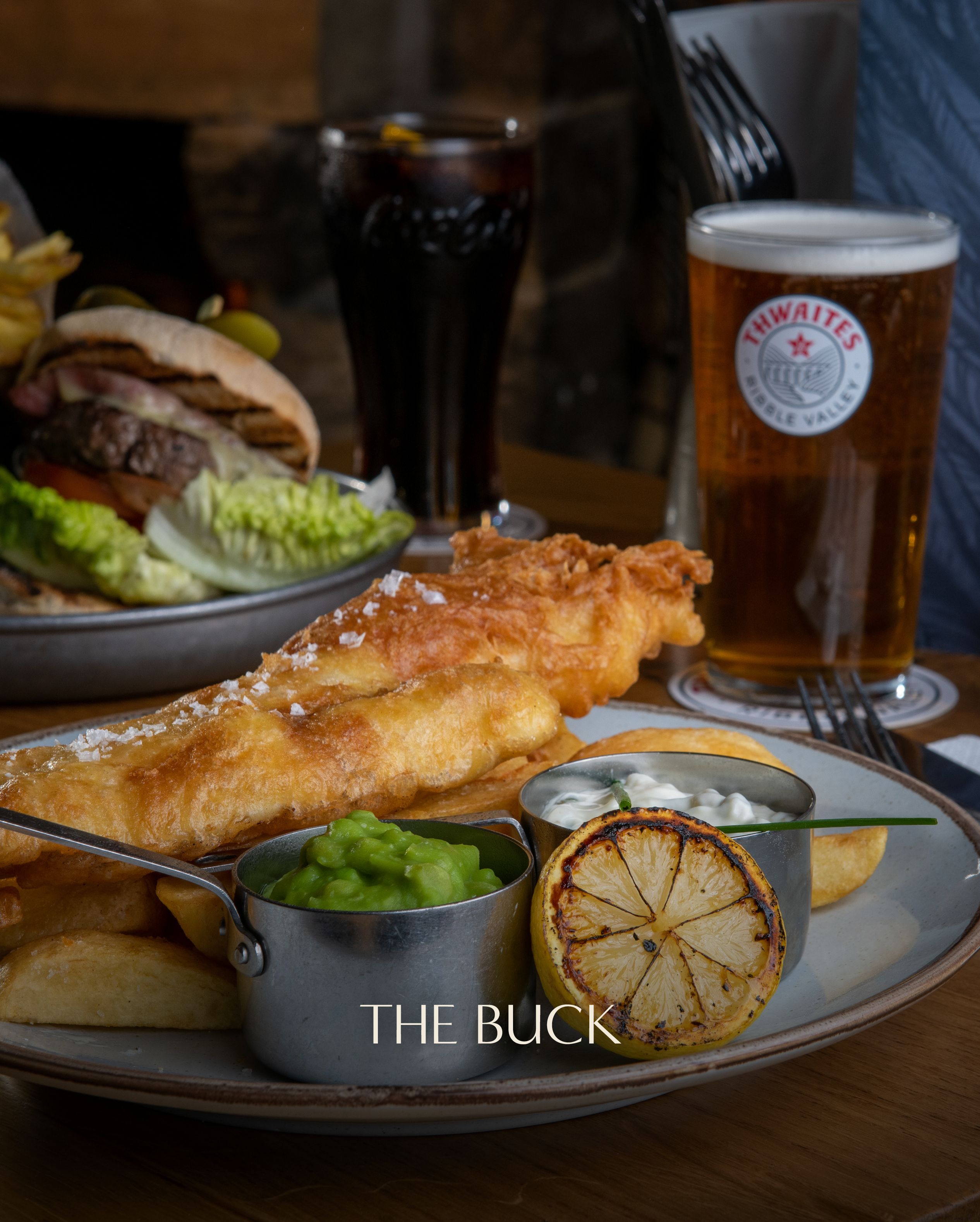 fish and chips with a pint of thwaites ale - the buck